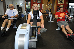 Three rowers working hard at the Concept2 indoor rowing instructor certification at Seattle's Pocock Rowing Center