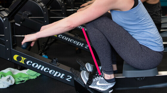image of a rower overcompressing, with the shins past perpendicular